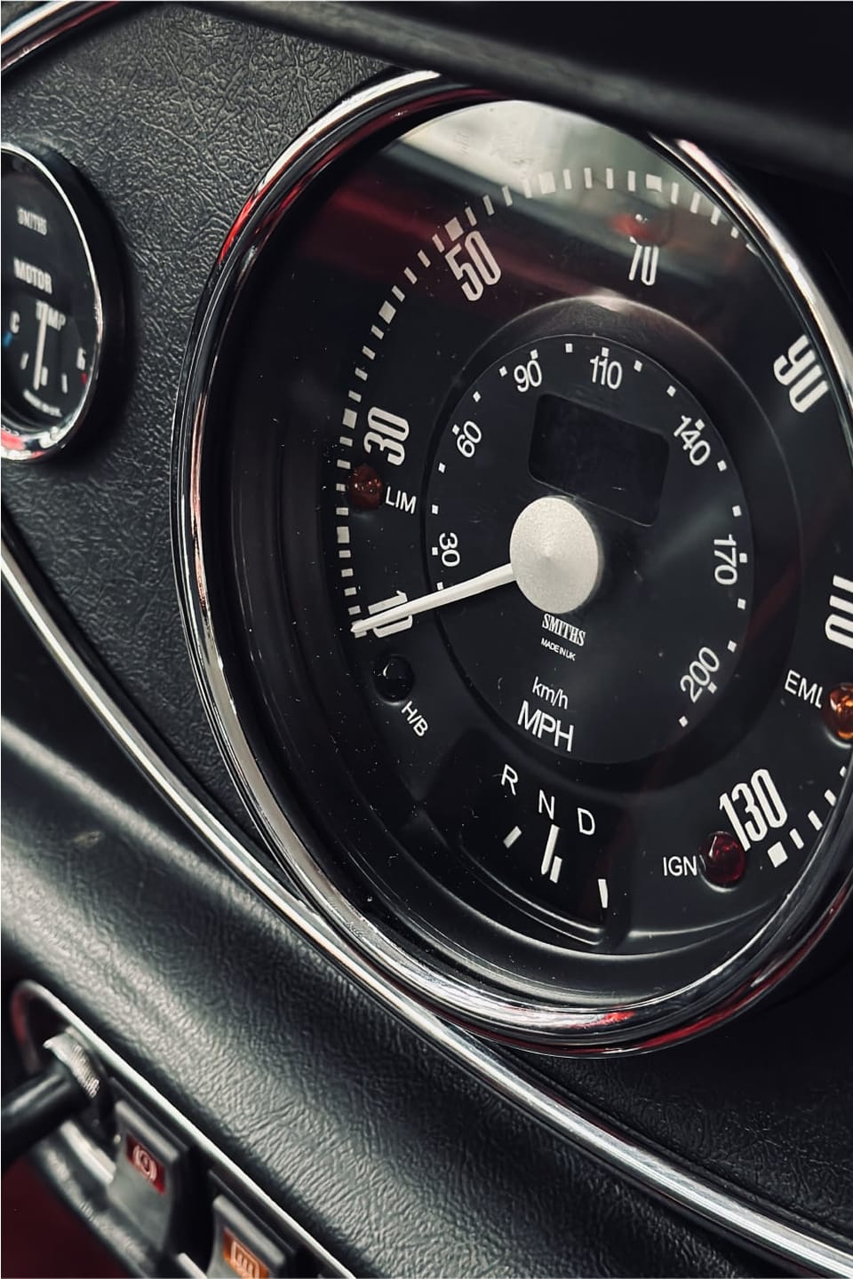 Close-up of the Mini's central gauge cluster reading speed and power.
