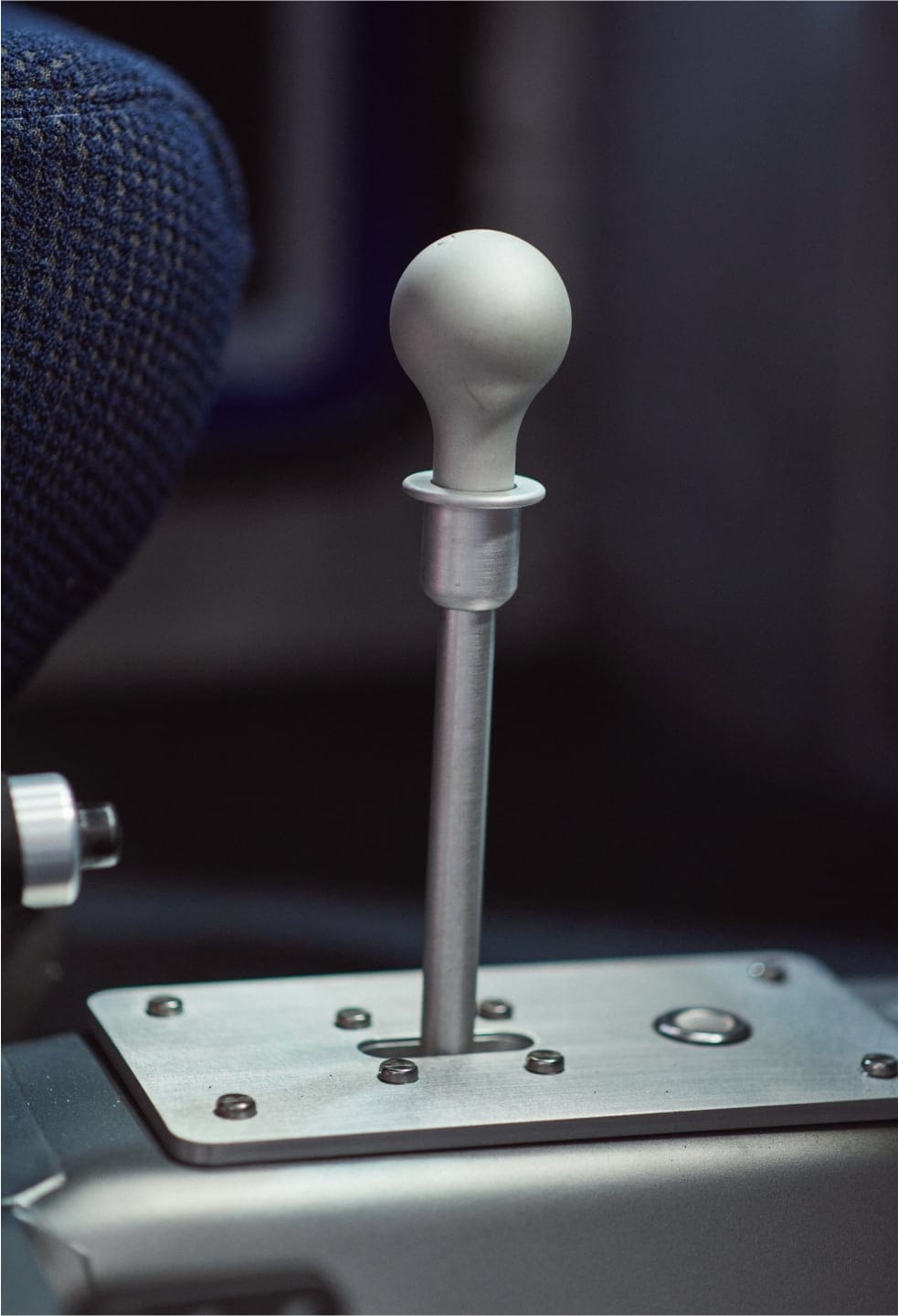 The Mini's brushed-aluminium gear selector plate with a D, N, R knob fitted over the original transmission tunnel.