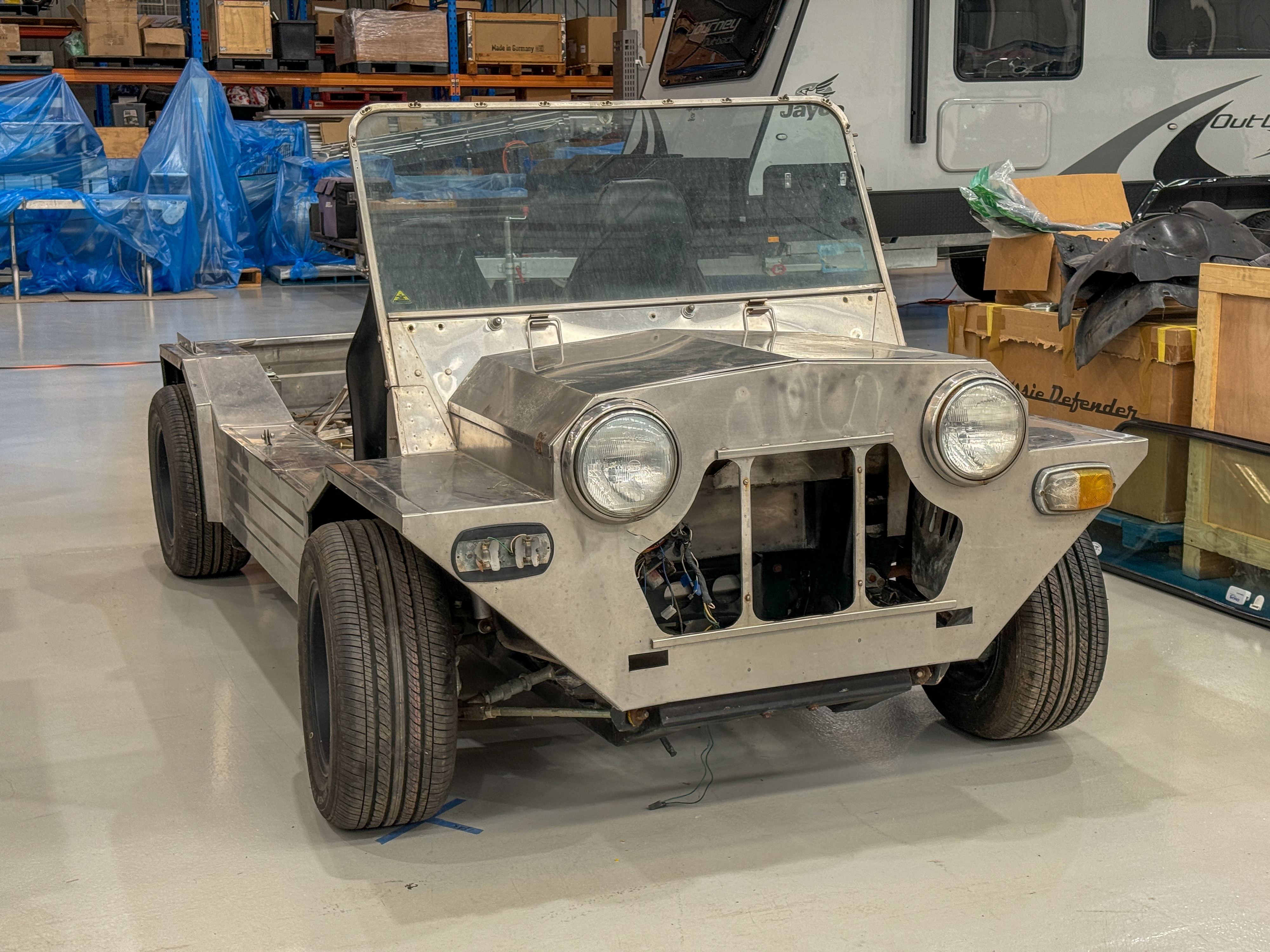 Front view of the partially restored stainless body on its original wheels as it arrived at the Jaunt workshop, before any conversion work began.